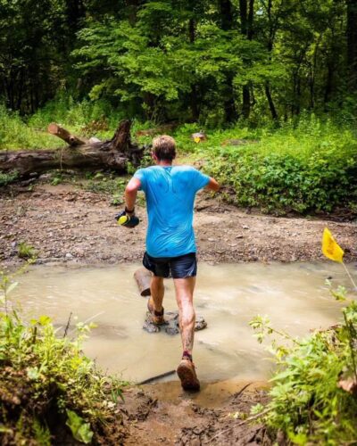 Arlen Glick running through mud at the 2021 BR100